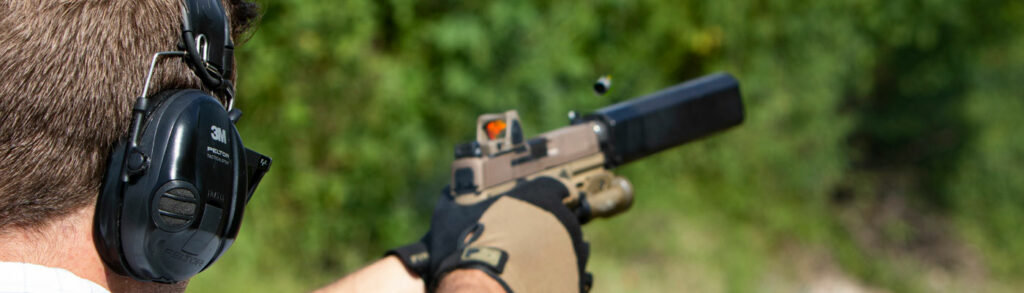 fde pistol with optic and suppressor hearing protection